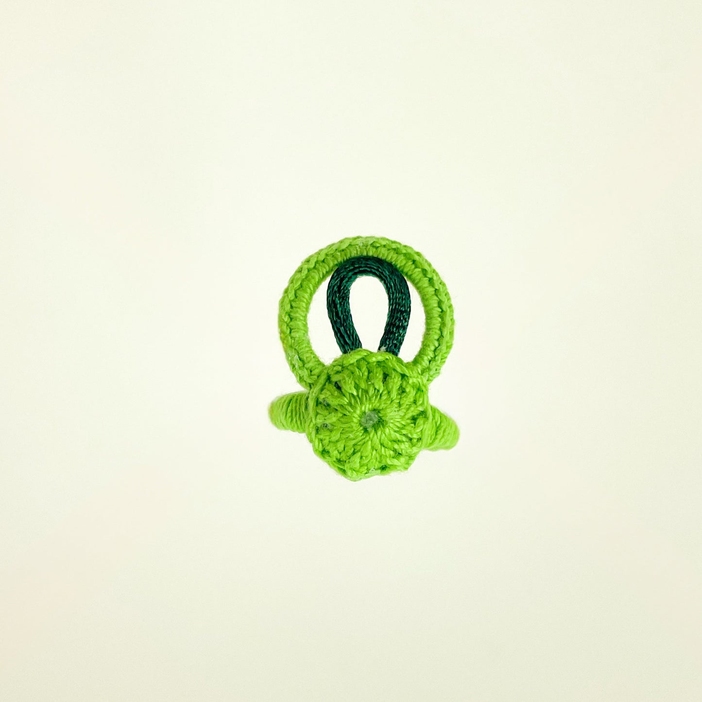 Top view of the green crochet ring from the Blossom collection, highlighting the vibrant color and circular pattern.