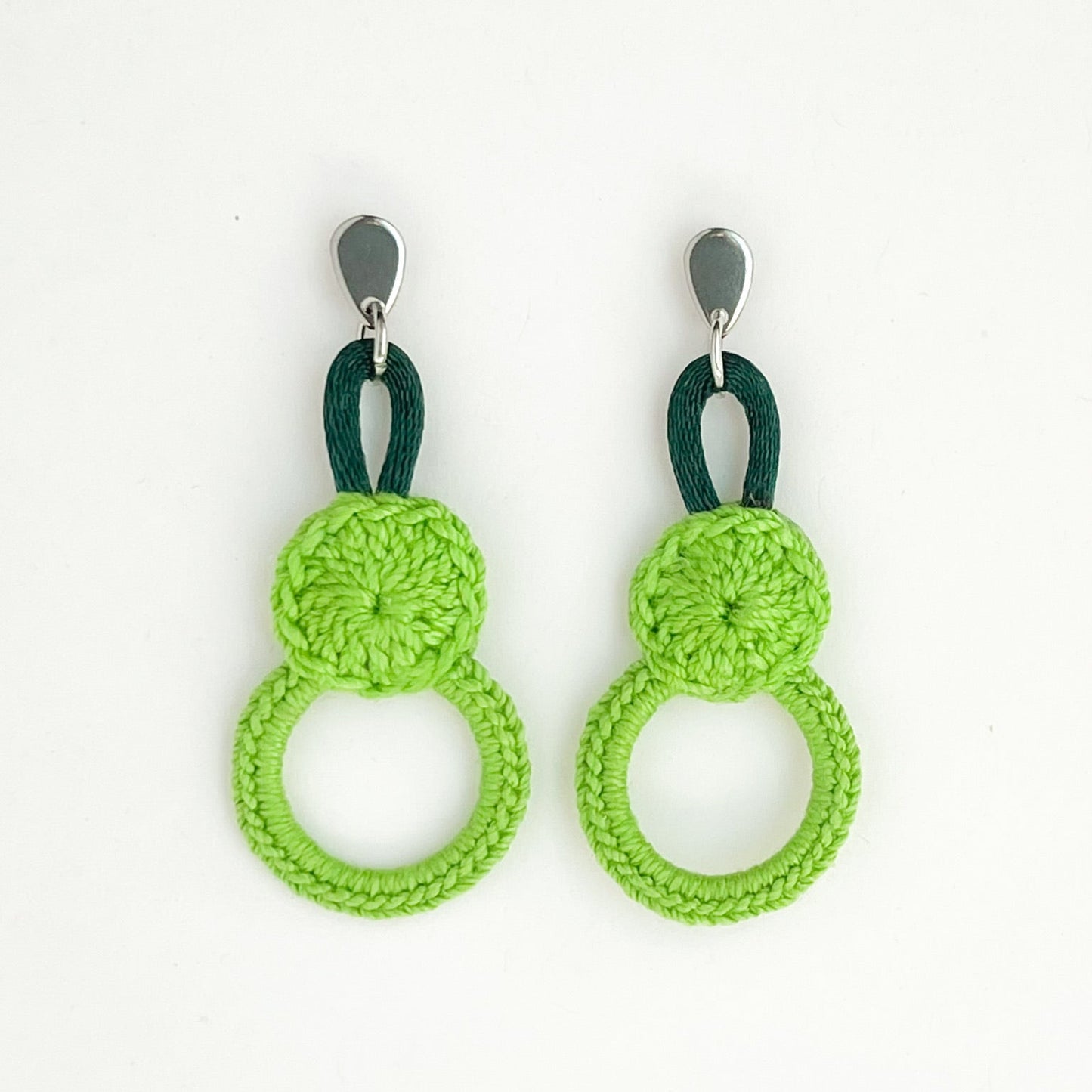Green crochet earrings with dark accent loops, artisan made.