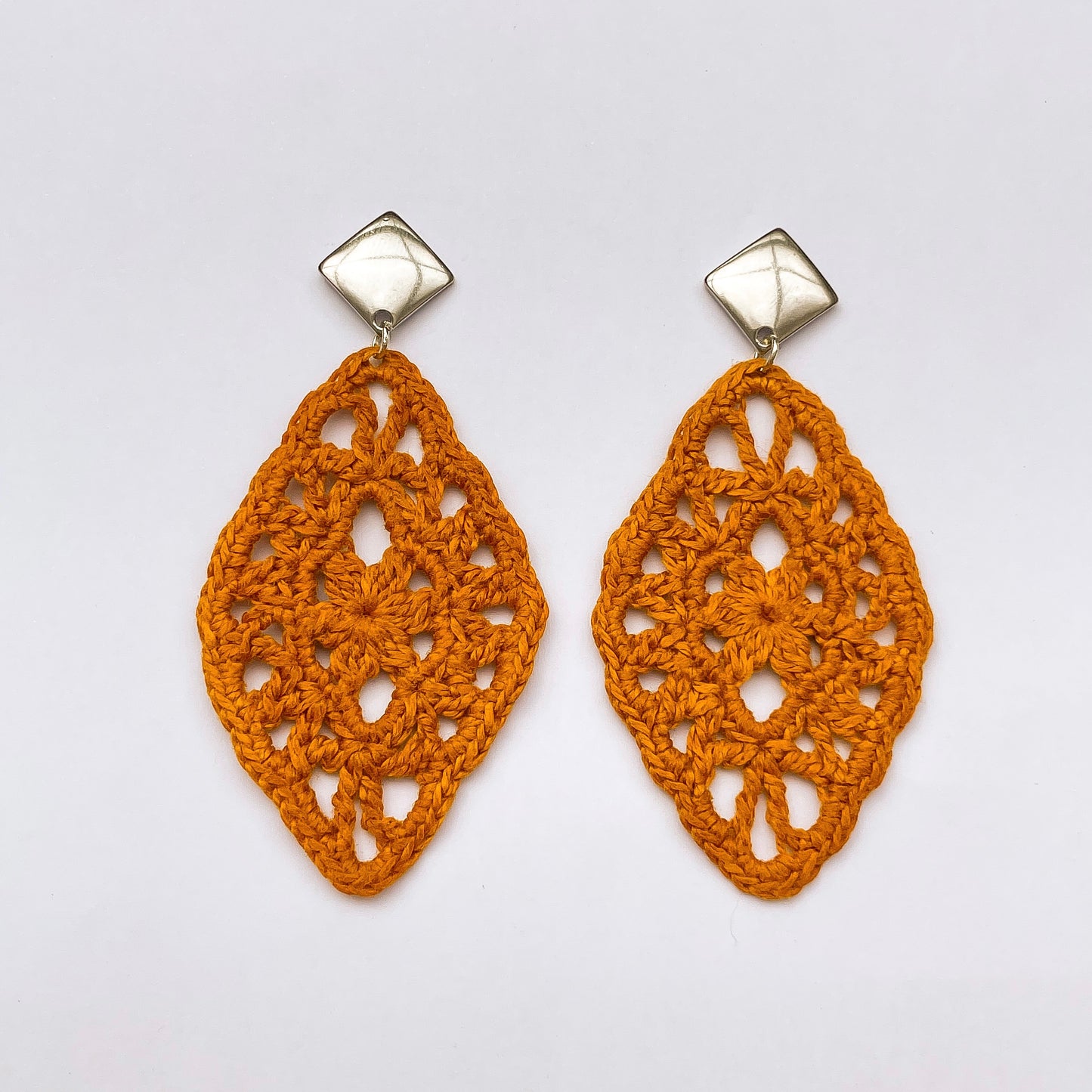 Handmade honey color crochet lace earrings with silver accents, adding a touch of elegance to any outfit. Square Post Earrings.