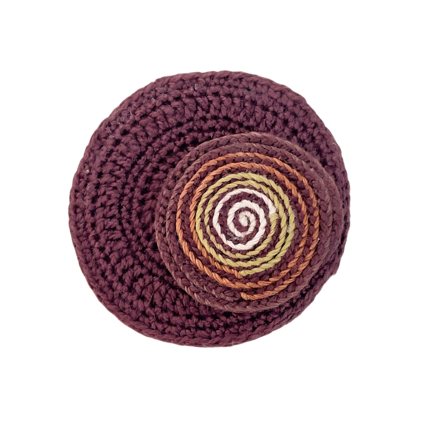 Handmade crochet Spiralis Pin in brown with brown, green and ivory spiral detail, front view on white background.