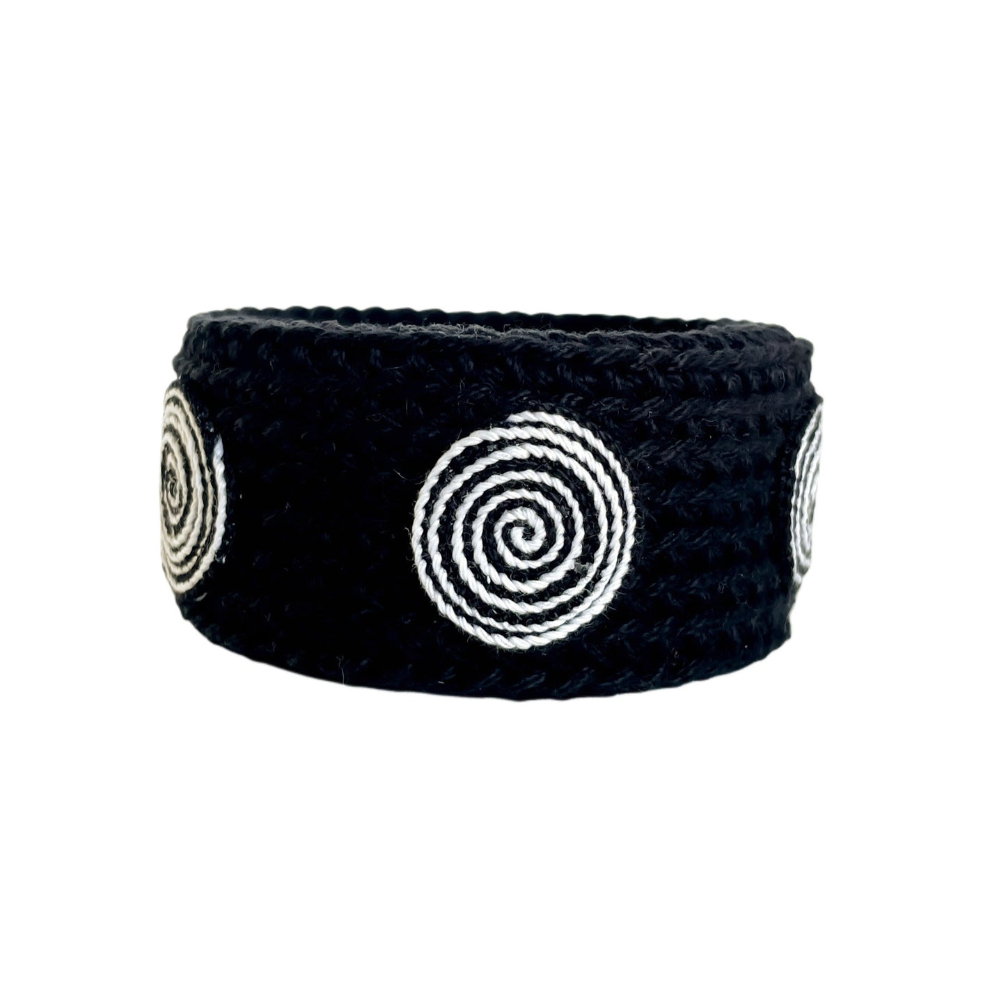 Black Spiralis crochet bracelet with black and white spiral design on a white background.