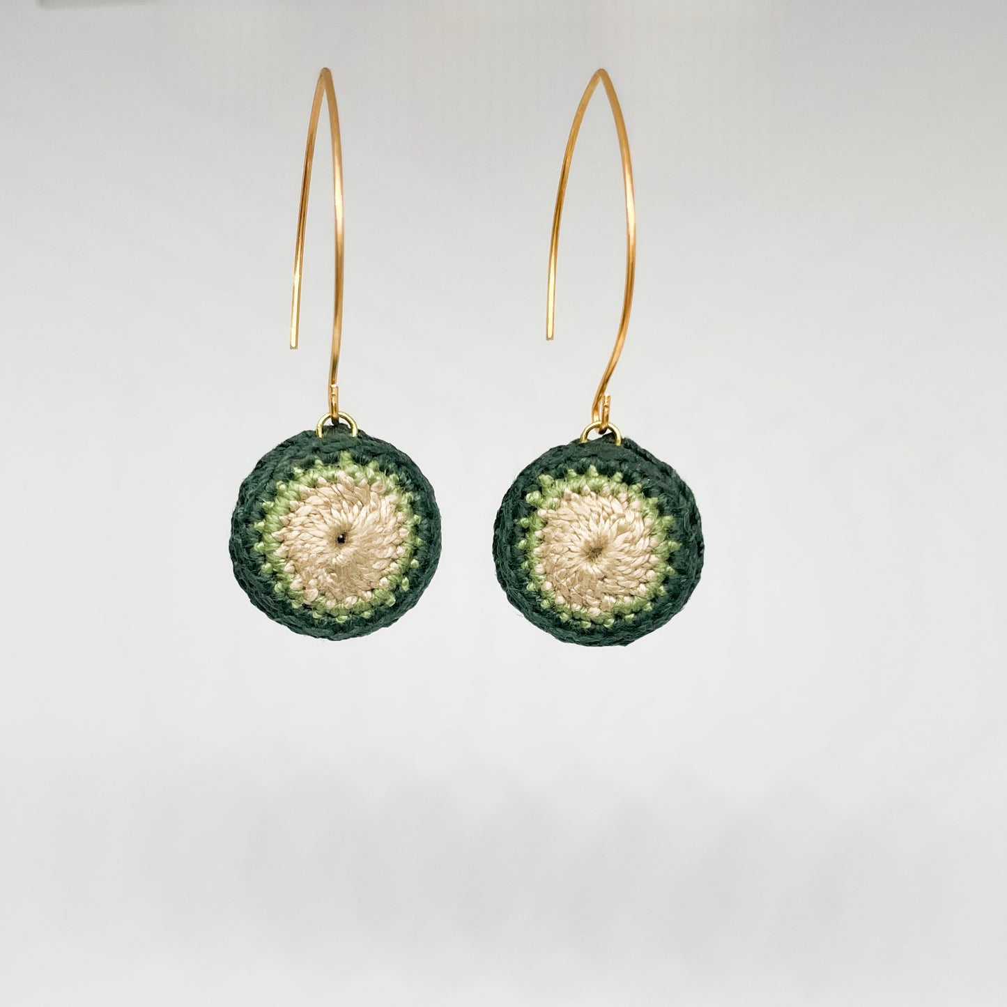 Green and gold crochet earrings, small and round in shape.