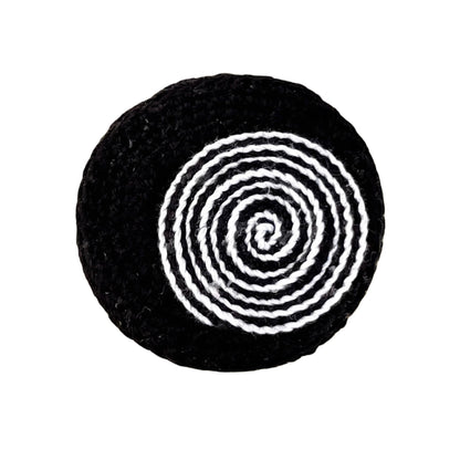 Handmade crochet Spiralis Pin in black with black and white spiral detail, front view on white background.