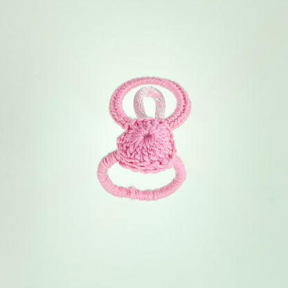Handmade crochet ring in light pink from the Blossom collection, highlighting its structure and volume.