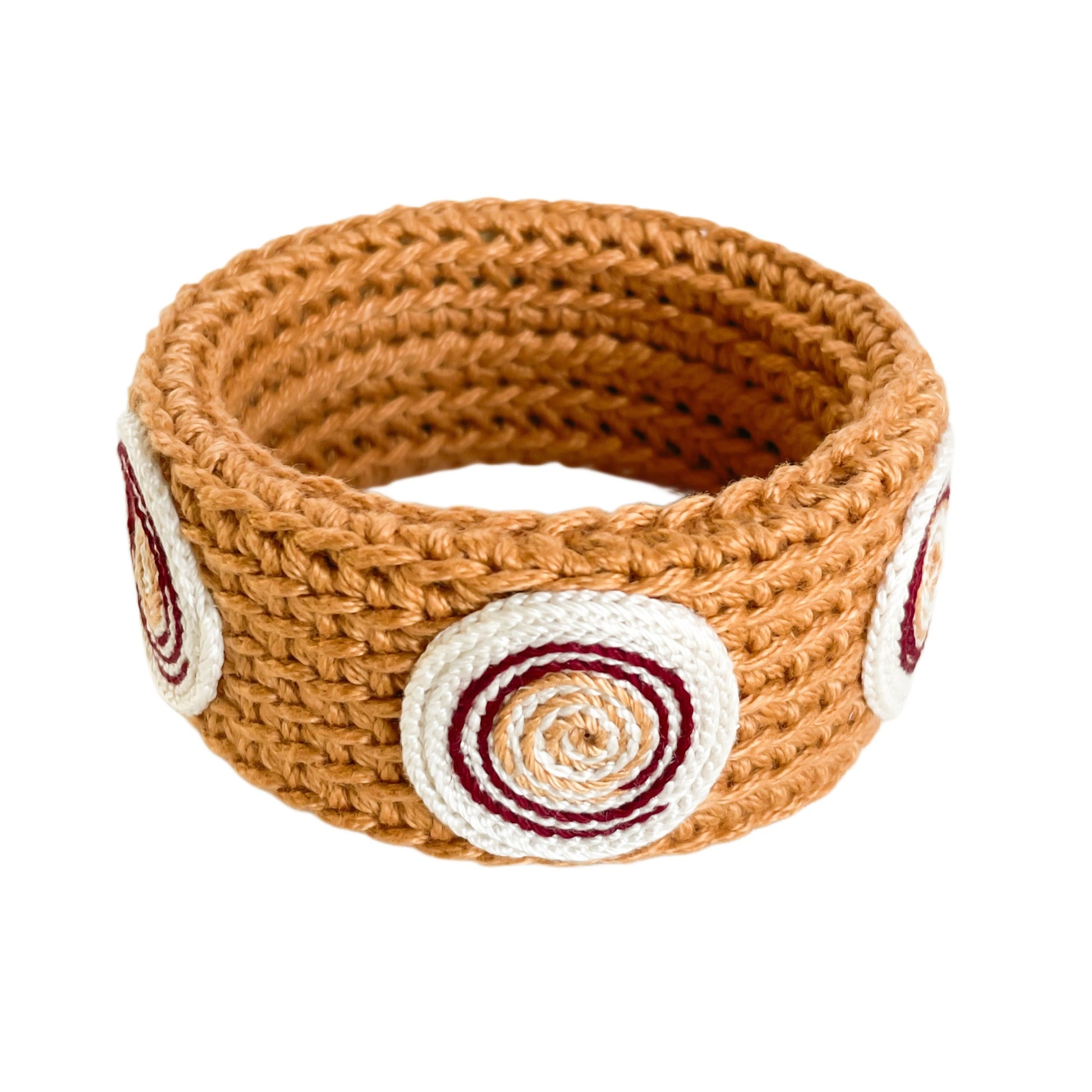 Amber Spiralis crochet bracelet with burgundy, Ivory and gold spiral design on a white background.