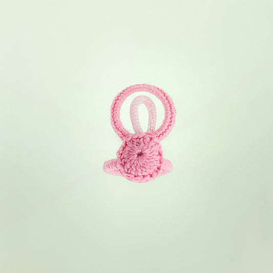 Top view of the Blossom collection crochet ring in light pink, featuring delicate circular stitching and soft texture.
