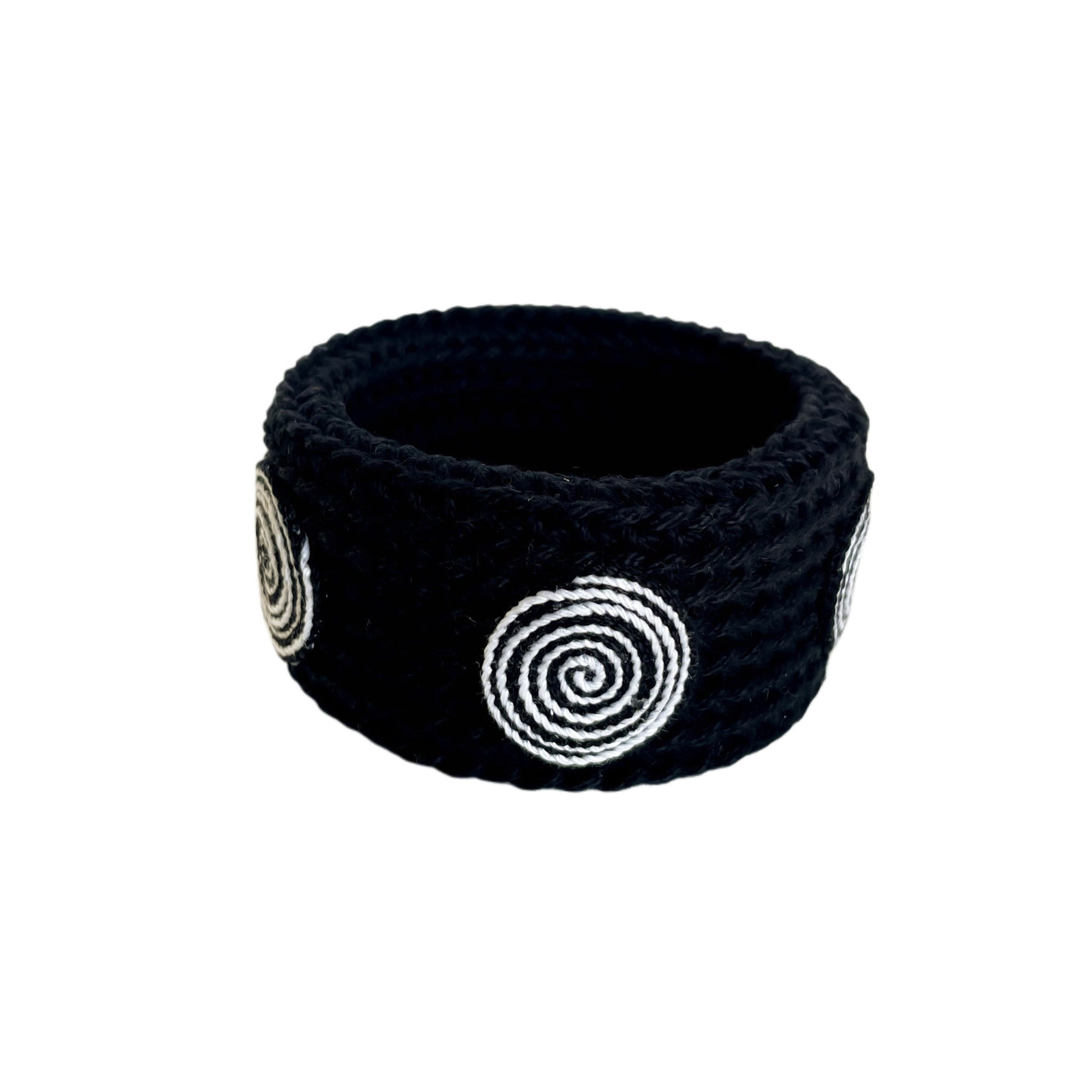 Black Spiralis crochet bracelet with black and white spiral design on a white background.