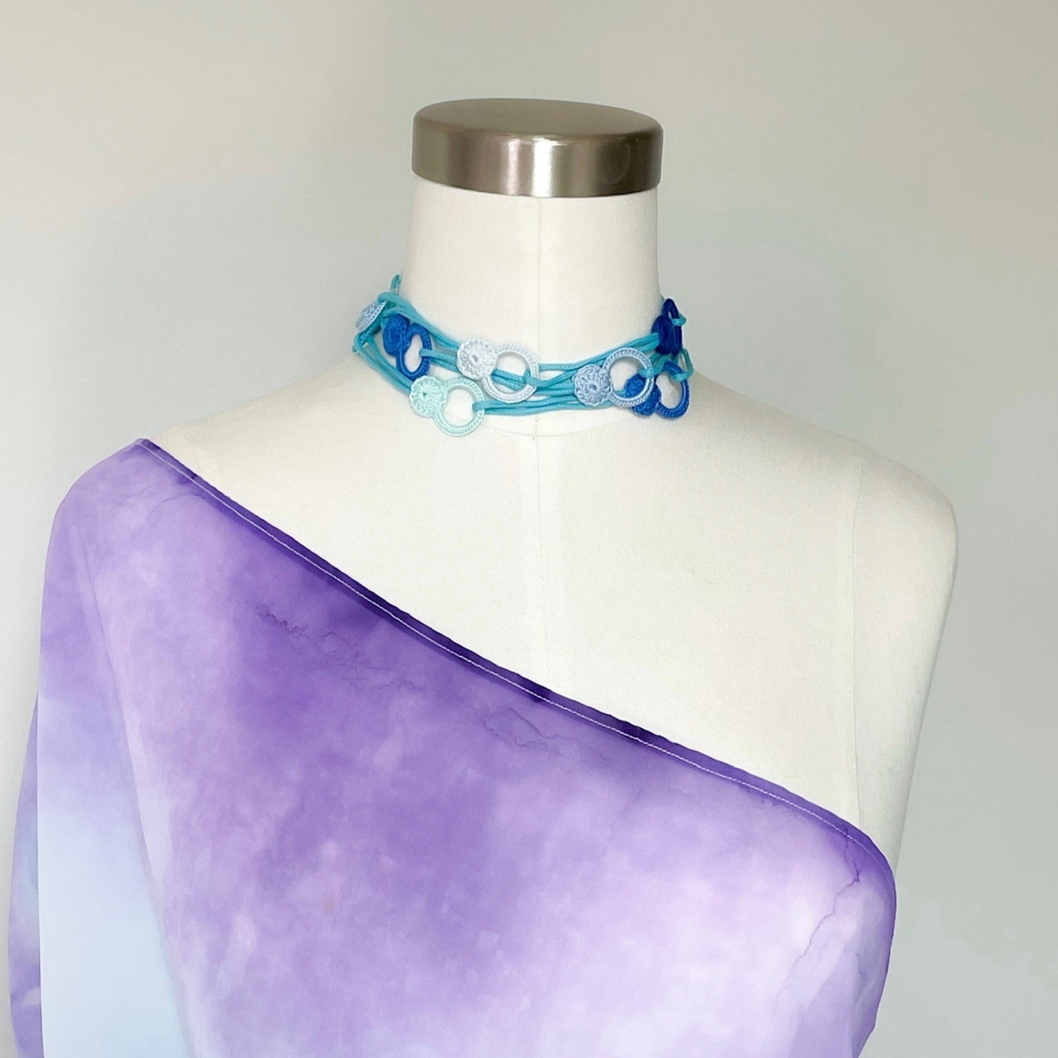Handmade crochet necklace worn as a choker, soft cotton thread wrapped close to the neck.