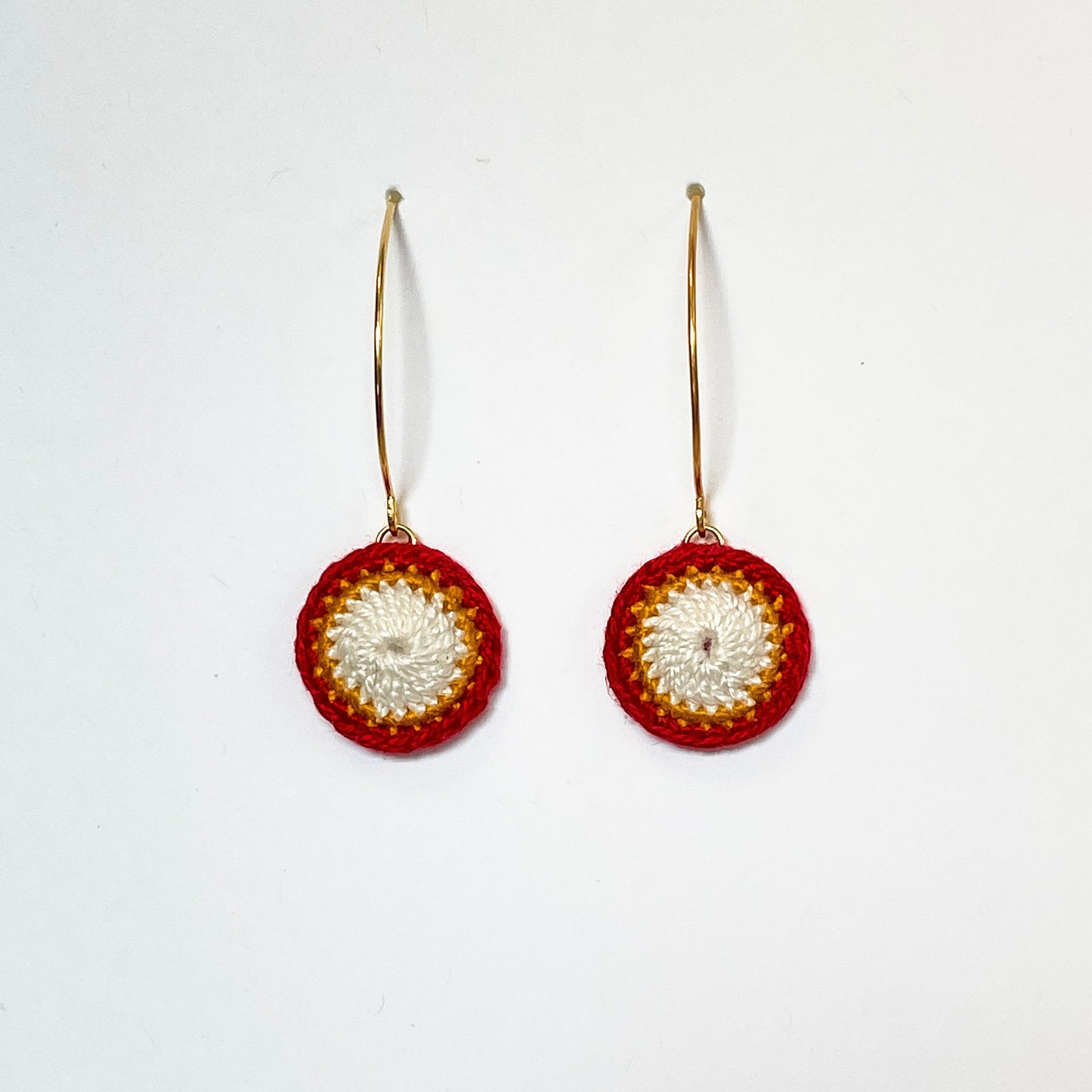 A beautiful pair of earrings made with red and white crochet technique. Delicate and stylish accessory for any occasion.