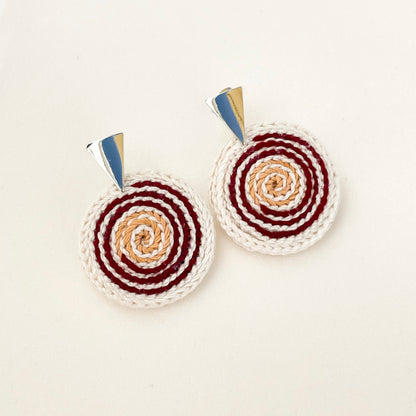 Spiralis Earrings in ivory, red and gold crochet with spiral pattern on a white background– handmade statement jewelry