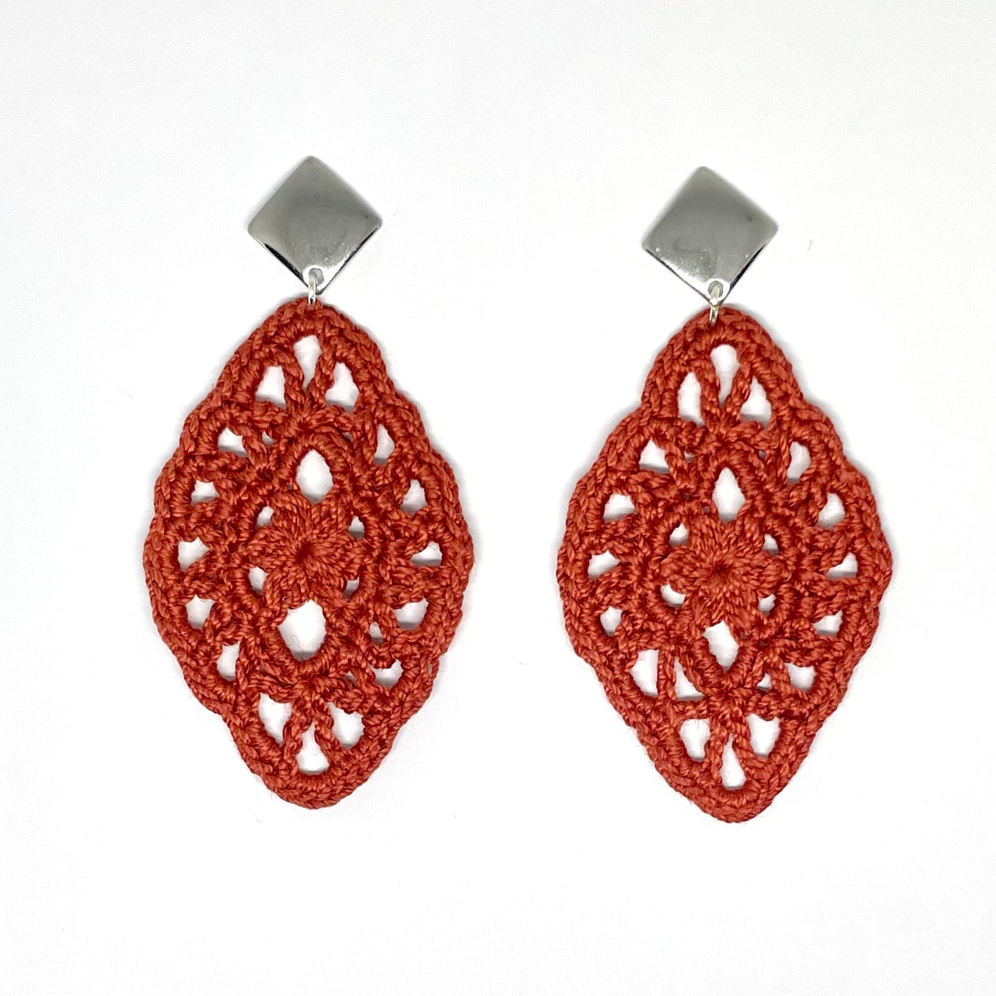 Handmade copper color crochet lace earrings with silver accents, adding a touch of elegance to any outfit.  Square Post Earrings.