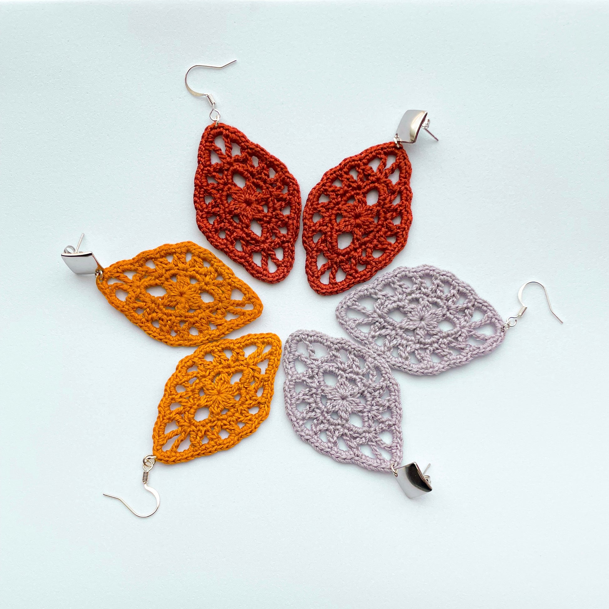 Crochet earrings in vibrant colors, showcasing intricate patterns and delicate craftsmanship. Perfect accessories to add a pop of style to any outfit.