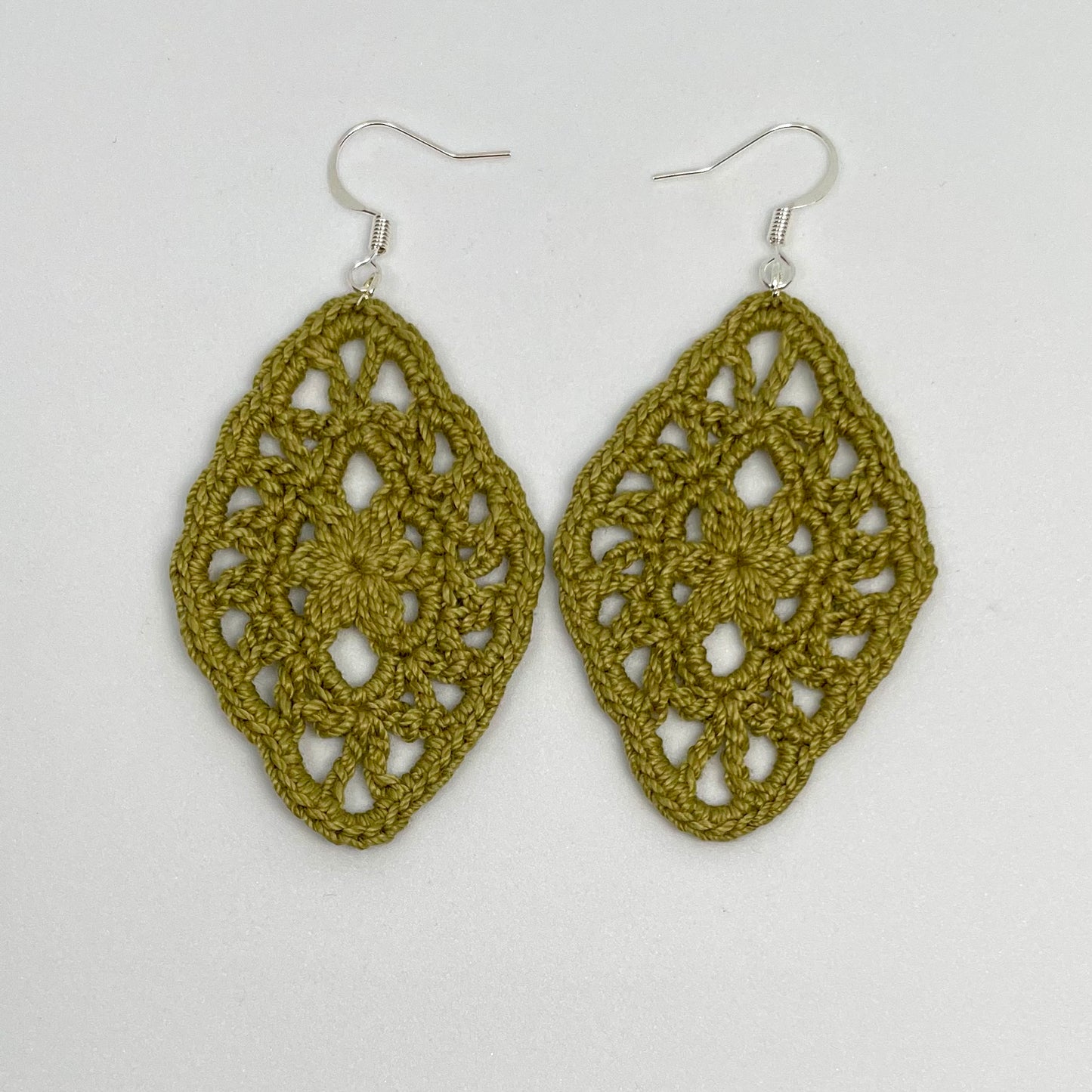 Handmade moss color crochet lace earrings with silver accents, adding a touch of elegance to any outfit. French hook ear wire.