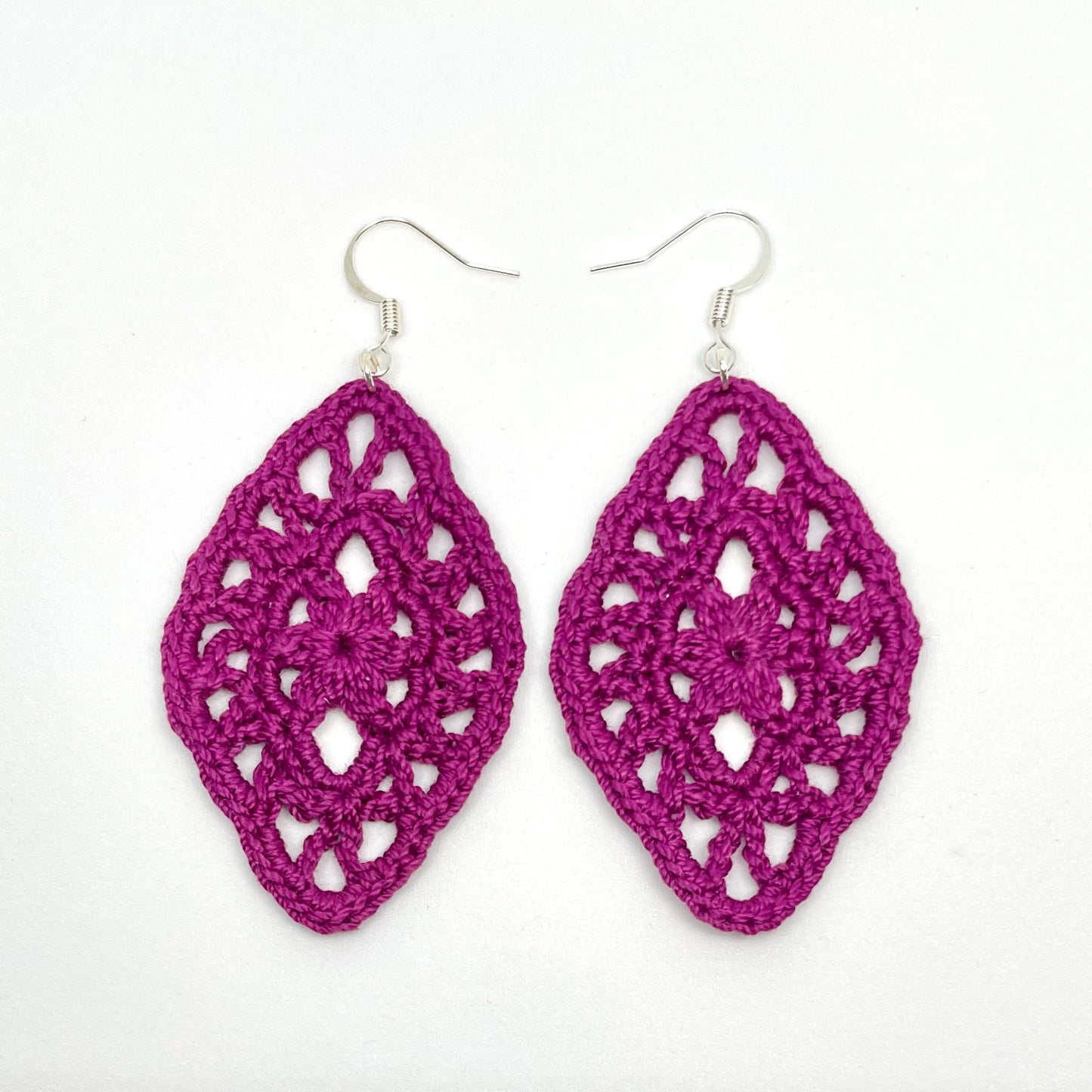 Handmade boysenberry color crochet lace earrings with silver accents, adding a touch of elegance to any outfit. French hook ear wire.