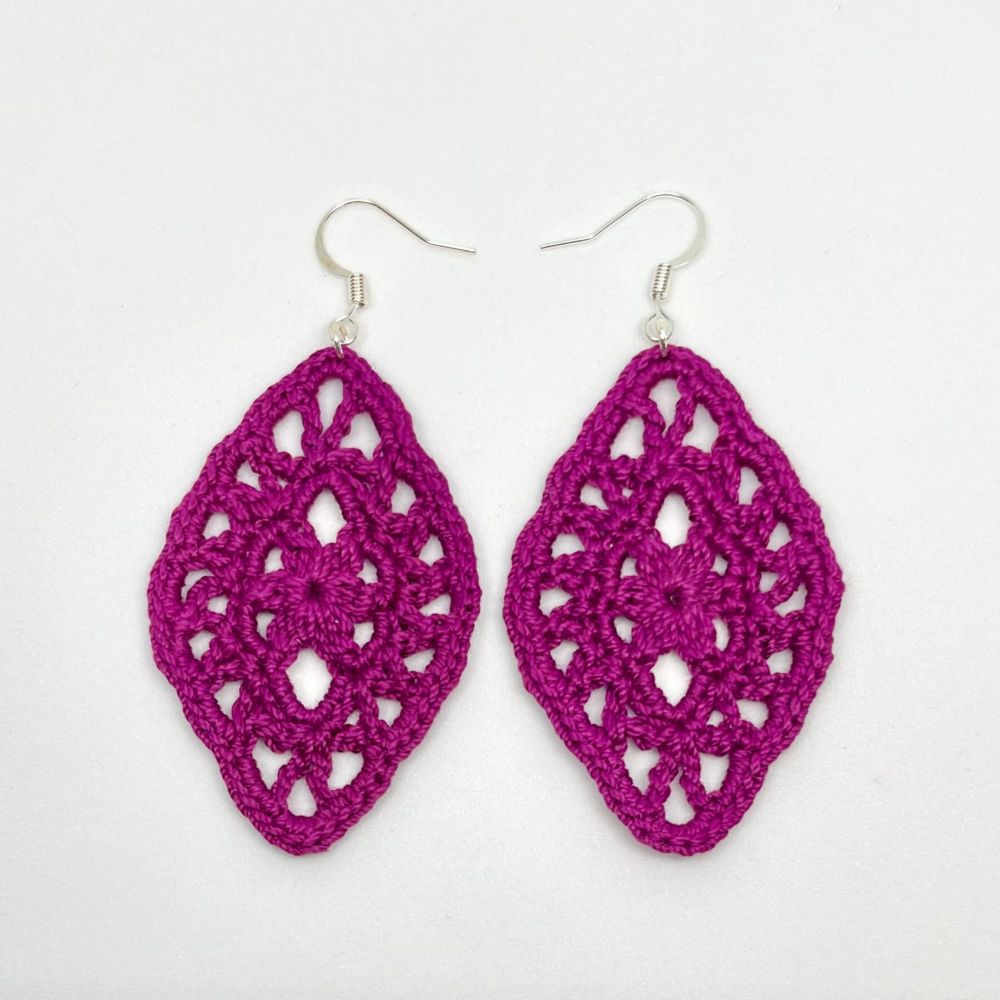 Handmade boysenberry color crochet lace earrings with silver accents, adding a touch of elegance to any outfit. French hook ear wire.