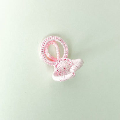 Back of the rose-colored Blossom collection crochet ring, highlighting the craftsmanship and neat finish of the adjustable band.