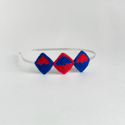 Tessera handmade crochet geometric headband with diamond-shaped motifs in blue and red mounted on metal band