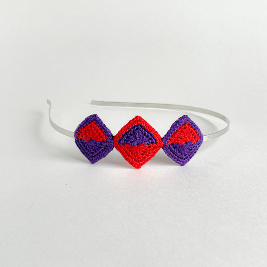 Tessera handmade crochet geometric headband with diamond-shaped motifs in violet and red mounted on metal band
