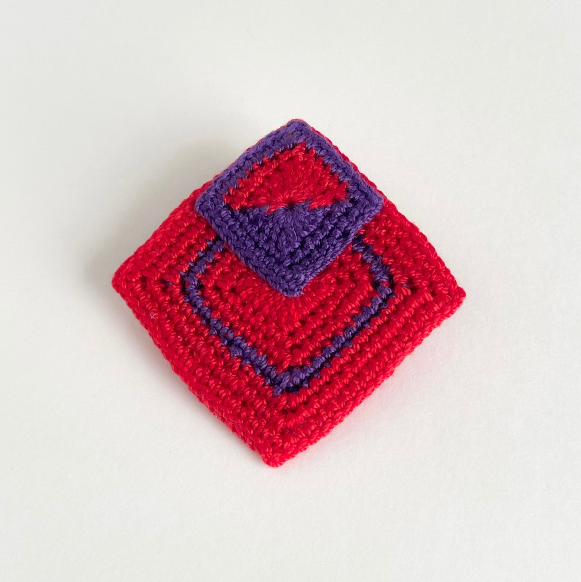Tessera handmade crochet geometric brooch in red and violet with layered square motifs by Crochet by Heart.