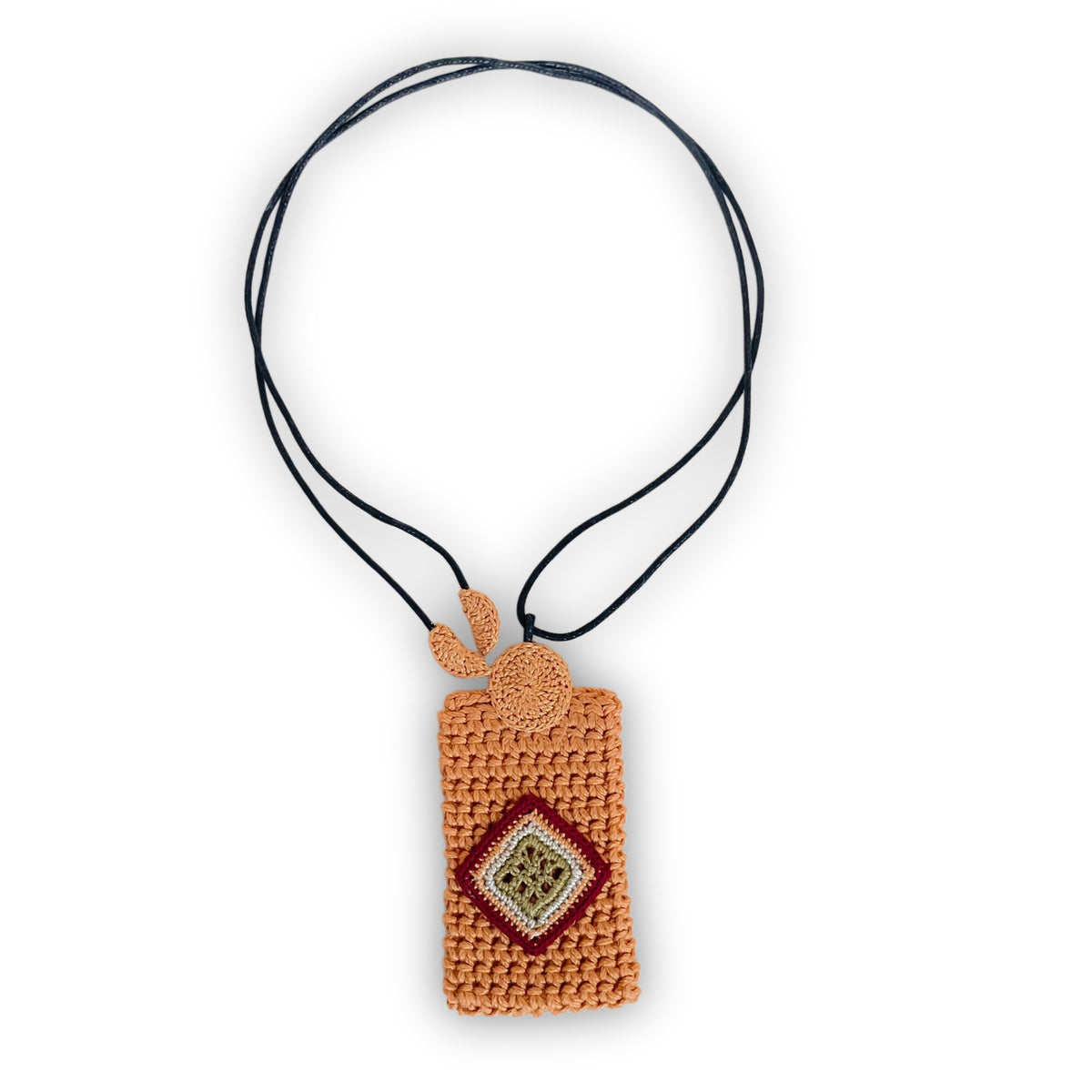 TRAMA crochet necklace with a marigold rectangular pendant, an olive, cream and burgundy diamond motif, and a black cord on a white background.